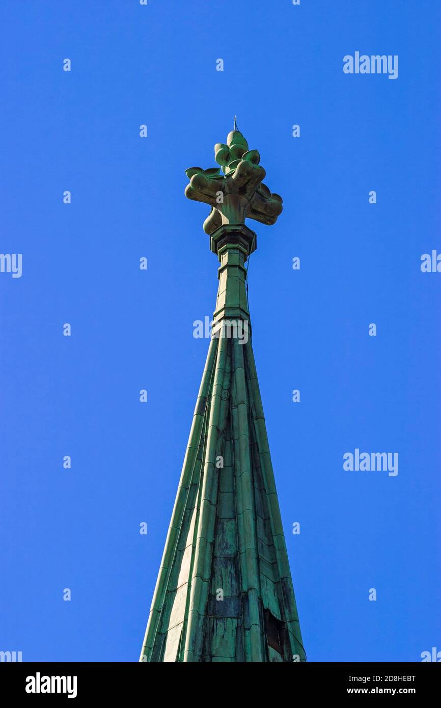 Church tower with spire against a blue sky Stock Photo