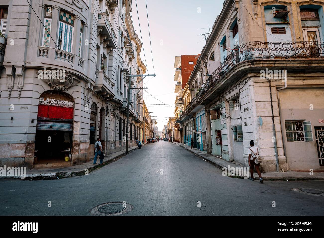 View of authentic street with old colonial buildings and local people at every day life. old part of Havana City. Stock Photo