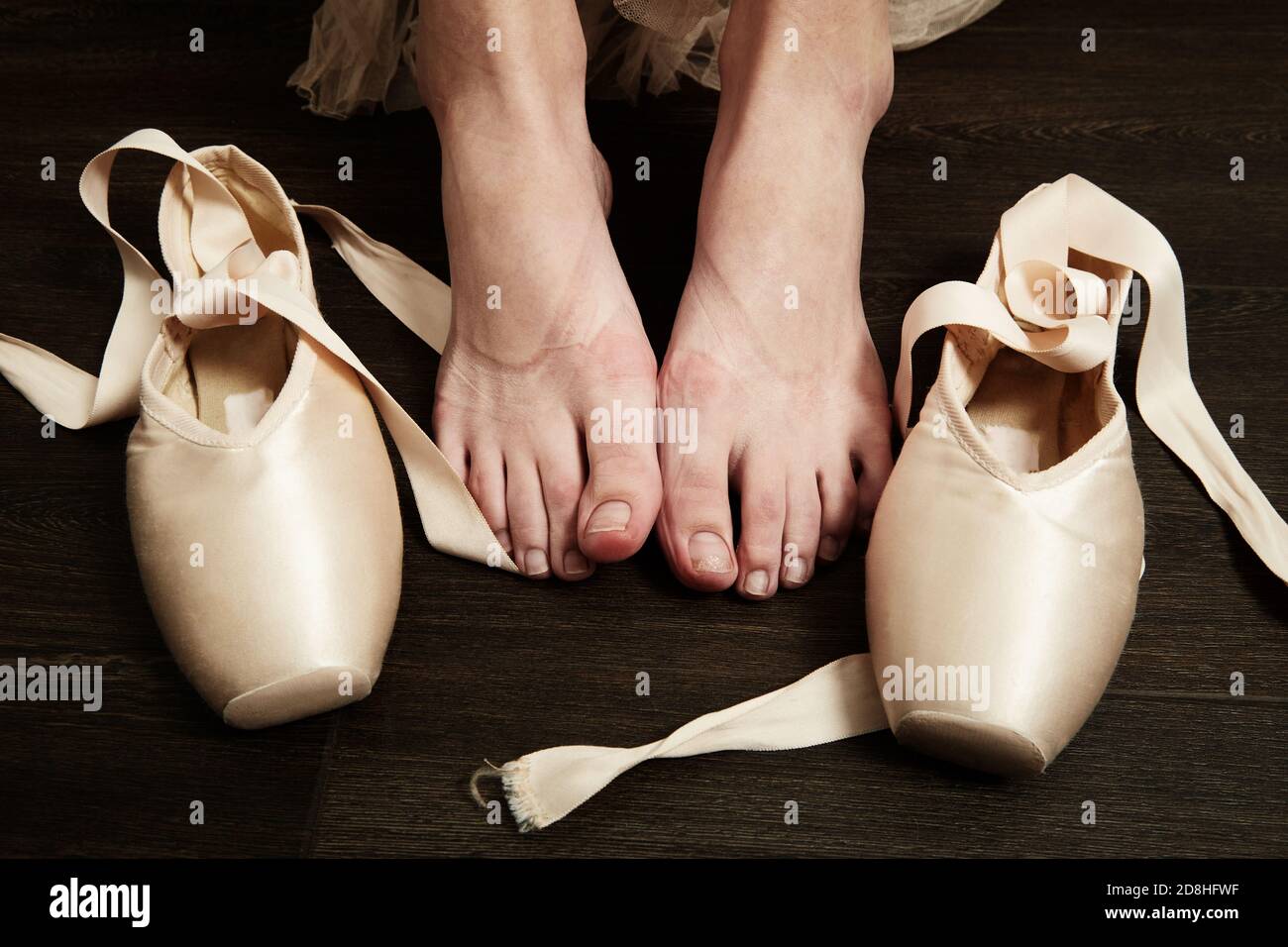 female ballerina feet with pointes after dance on a wooden floor closeup image Stock Photo