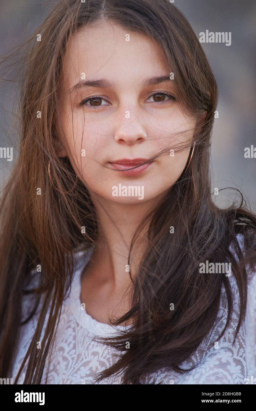 beautiful attractive girl with long hair looking at camera smiling Stock Photo