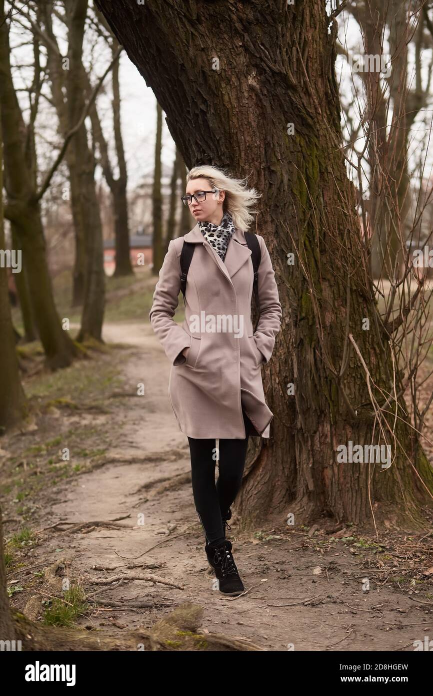 sad young woman walking at old autumn park Stock Photo