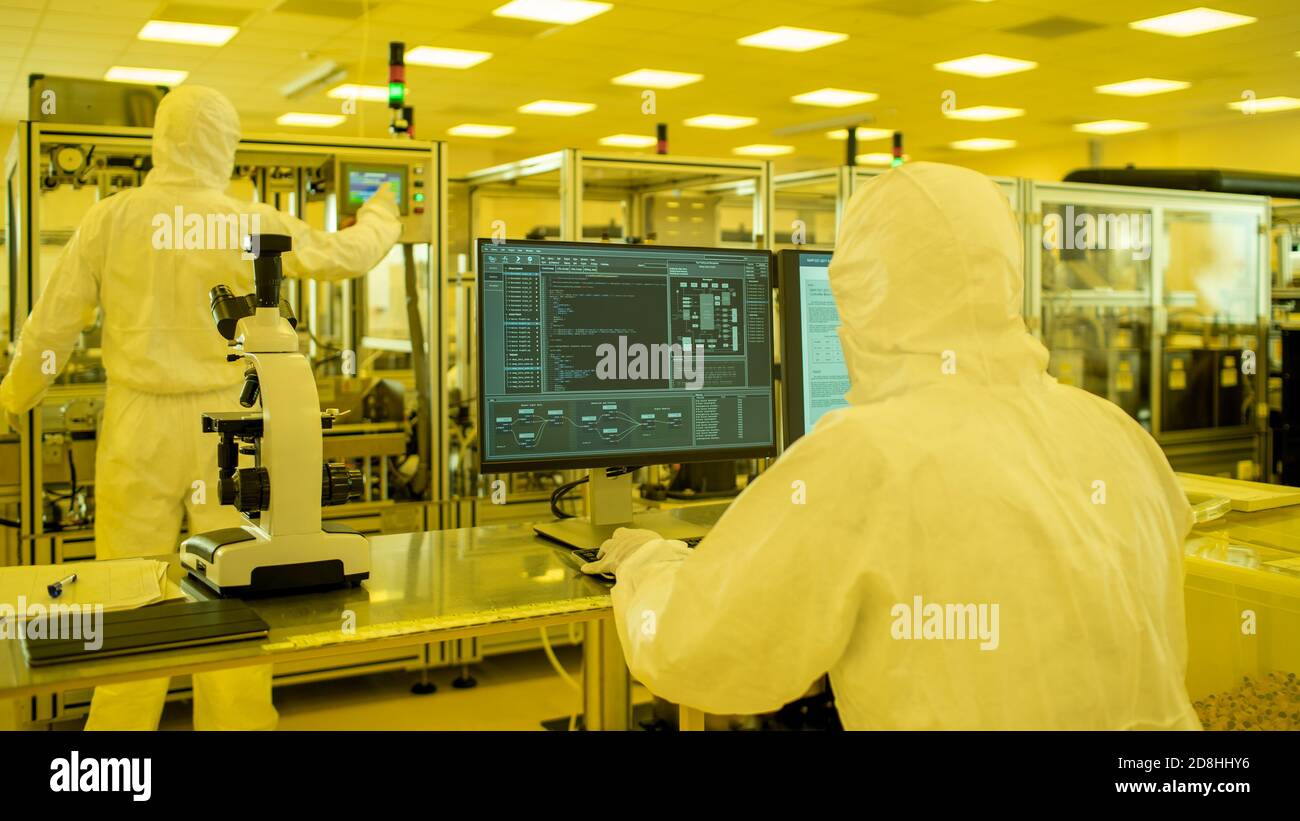 Sterile Processing Computer Shot of a Scientists in Sterile Suits Working with Computers, Analyzing ...