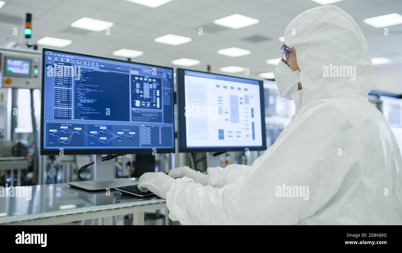 Shot of Scientists in Sterile Suits Working with Computers, Analyzing