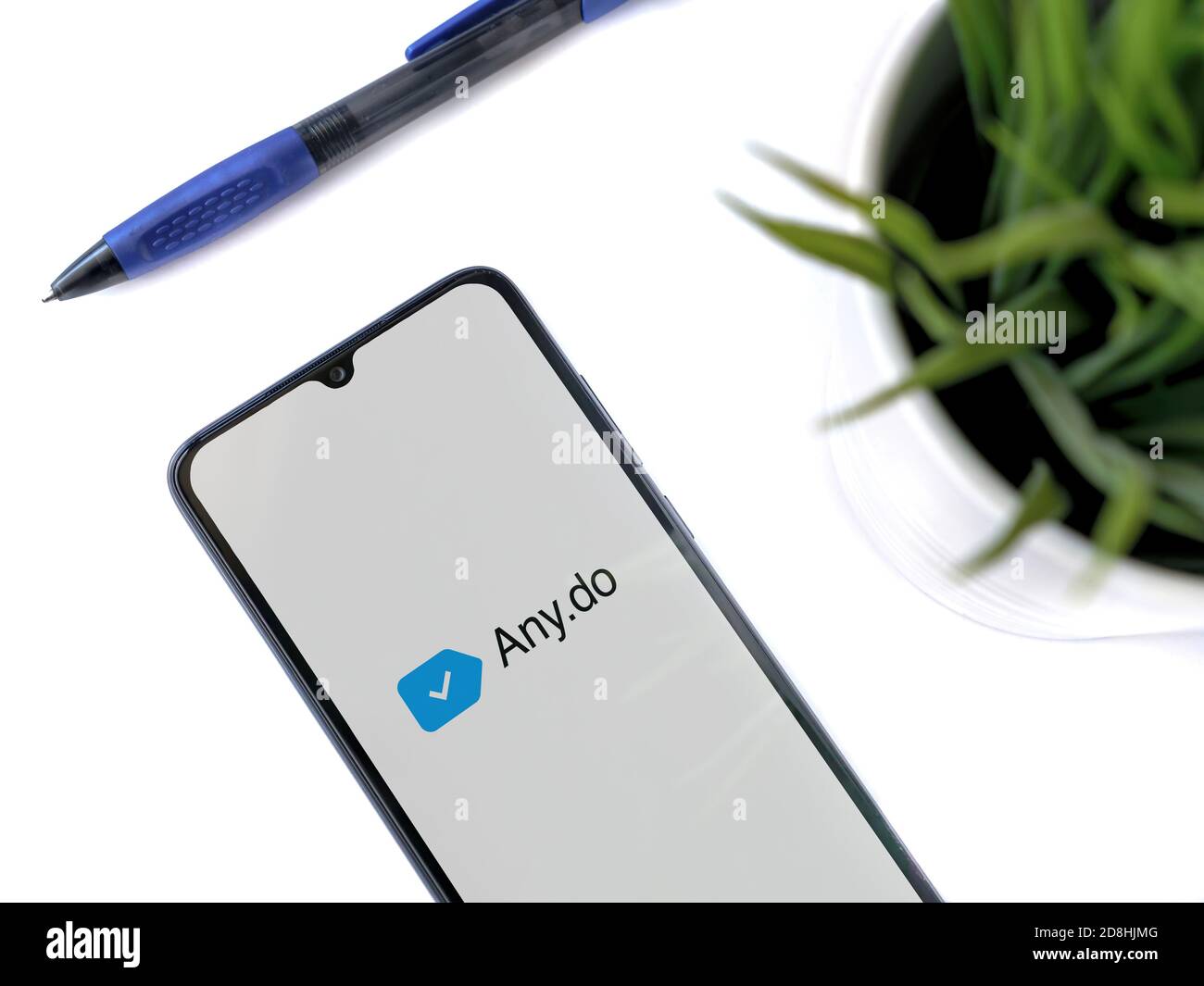 Lod, Israel - July 8, 2020: Modern minimalist office workspace with black mobile smartphone with Any.Do app launch screen with logo on white backgroun Stock Photo