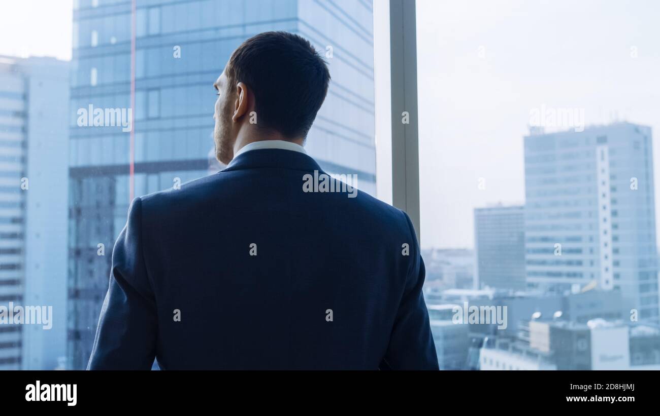 Medium Shot of Successful Businessman wearing a Suit Standing in His ...