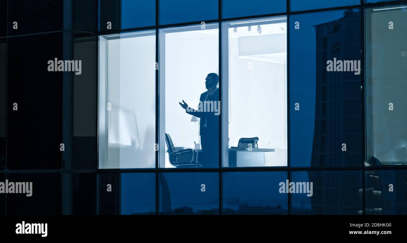 Aerial Shot: From Outside into Office Building with Businessman Using