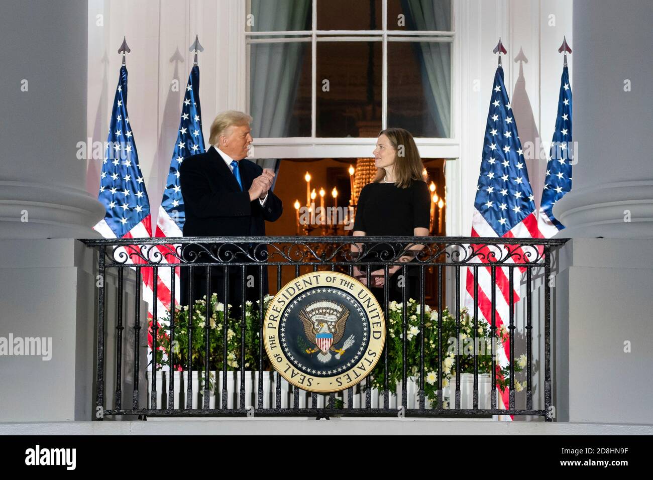 U.S President Donald Trump applauds Supreme Court Associate Justice Amy Coney Barrett from the Blue Room Balcony of the White House following the swearing in ceremony October 26, 2020 in Washington, DC. Stock Photo