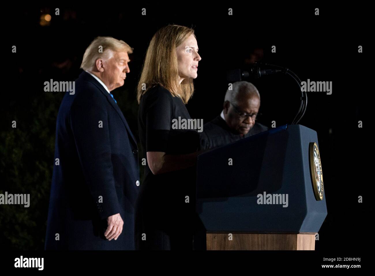 Supreme Court Associate Justice Amy Coney Barrett delivers remarks during her swearing in ceremony on the South Lawn of the White House October 26, 2020 in Washington, DC. Joining Barrett onstage are President Donald Trump and Supreme Court Associate Justice Clarence Thomas. Stock Photo