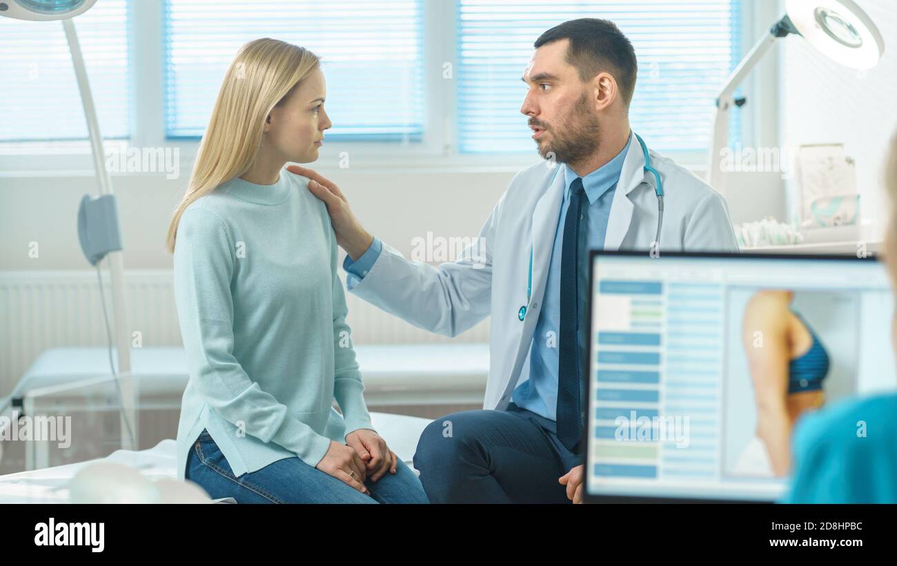 Friendly Doctor Consoles Female Patient, Lightly Touching Her Shoulder