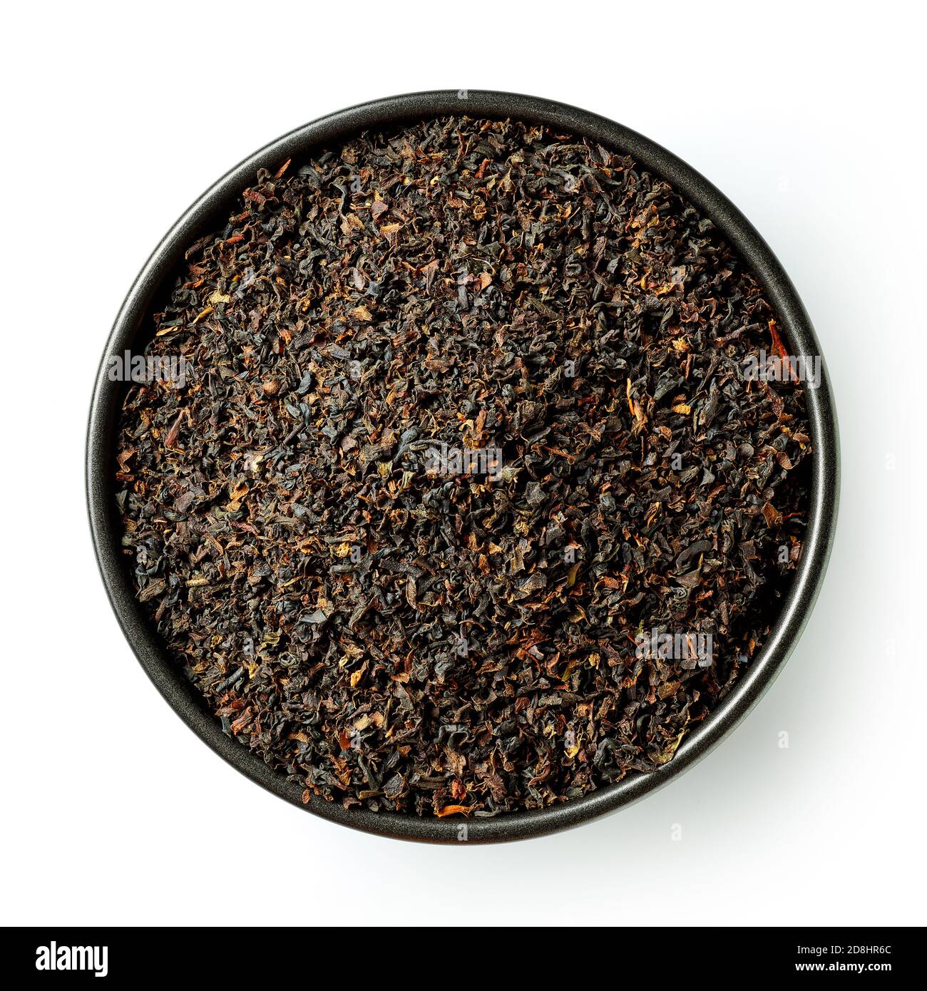 Black bowl of dried Ceylon black tea leaves isolated on white