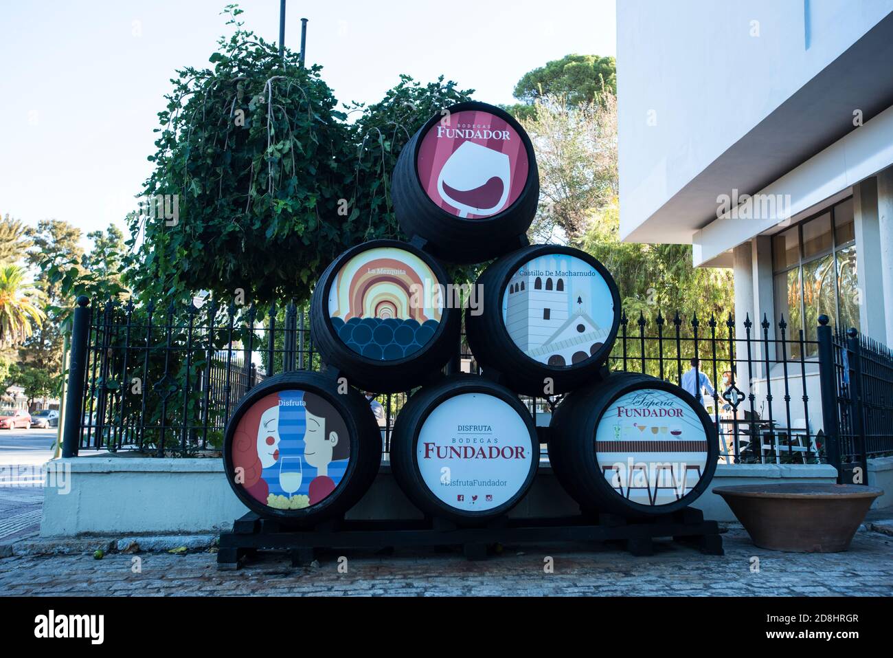 Several sherry wine barrels stacked in front of Hotel NH in Jerez de la Frontera Stock Photo