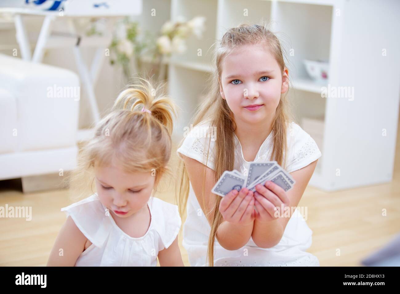 Children play a game with cards at home Stock Photo