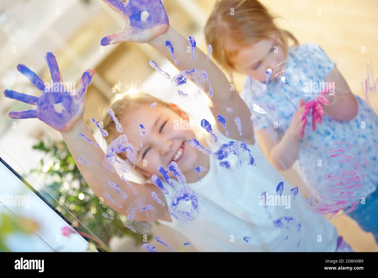 Laughing children have fun with colored fingers in kindergarten Stock Photo