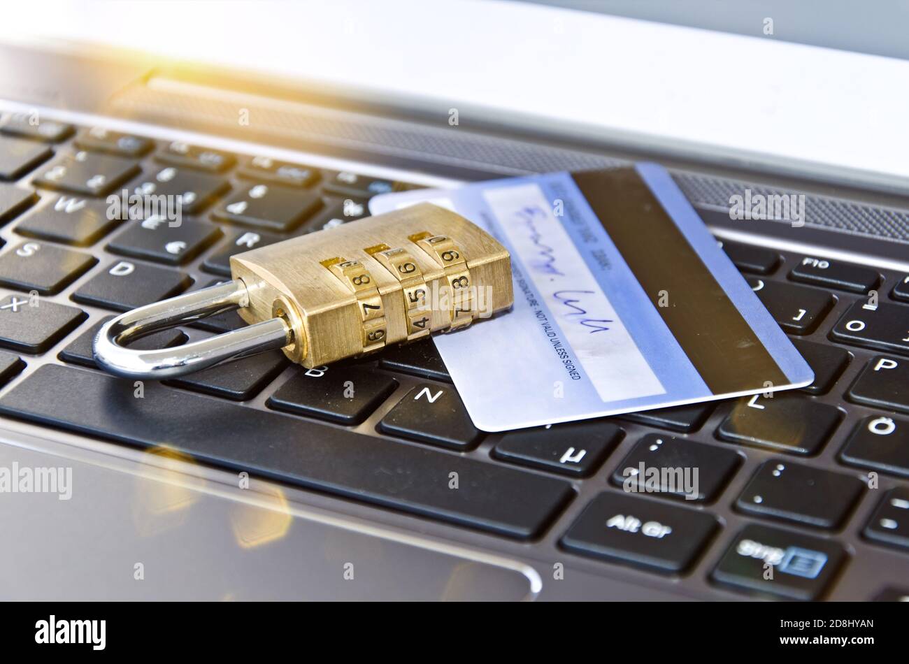 Credit card with padlock on computer keyboard symbolising secure online banking or payment Stock Photo