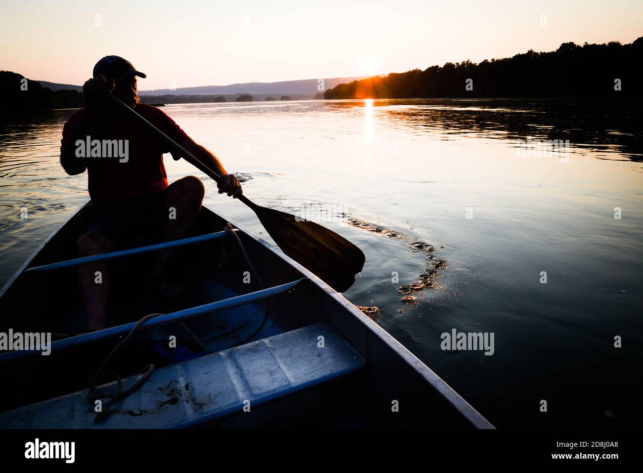 Canoeist at dusk on the Susquehanna River near Harrisburg, Pennsylvania, USA. Stock Photo