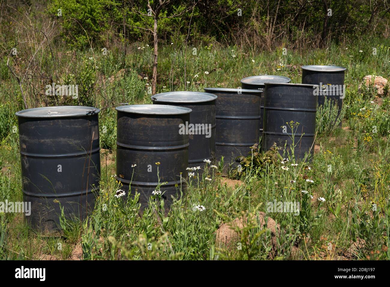 Empty metal drums abandoned in a field Stock Photo