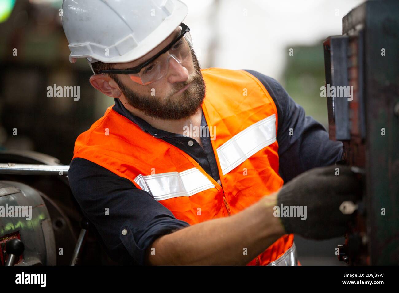 Engineers operating a cnc machine in factory Stock Photo