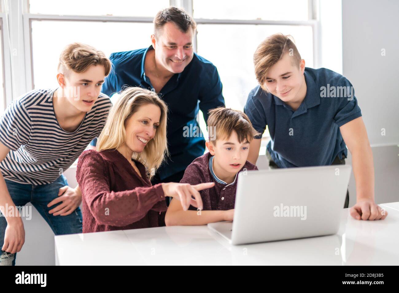 big family looking in computer at home Stock Photo - Alamy