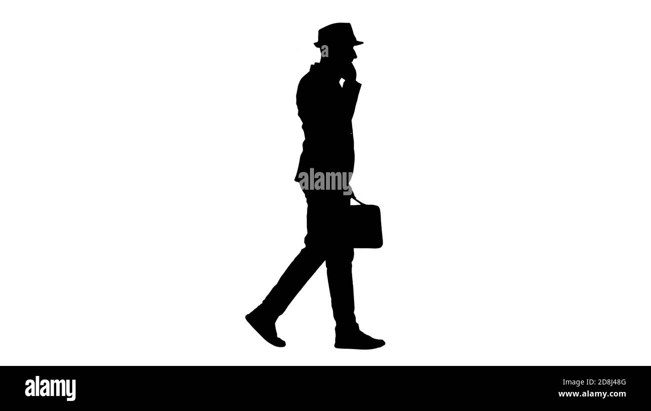 Silhouette Arabic man in casual walking and making a phone call. Stock Photo