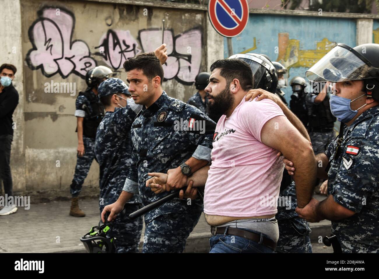 Beirut, Lebanon, 30 October 2020. A man is arrested as a small group of people from Tripoli and Beirut clashed with Lebanese Interior Security Forces during an attempt by pan-islamic group Hizb Ut Tahrir to march to the French Embassy in protest of what they view as president Emmanuel Macron's anti-islamic stance. Emotions ran high as it was felt the Prophet Mohammed is being disrespected during his birthday month. Credit: Elizabeth Fitt/Alamy Live News Stock Photo