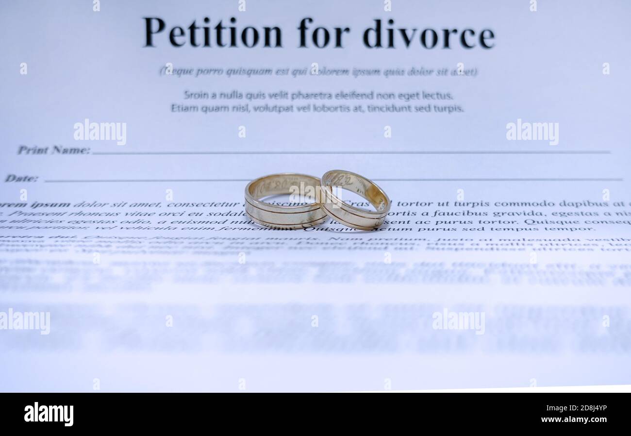 Conceptual image for divorce with two golden wedding ring in the middle