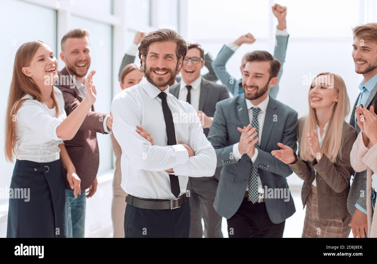 confident young businessman standing in front of a happy busines Stock ...