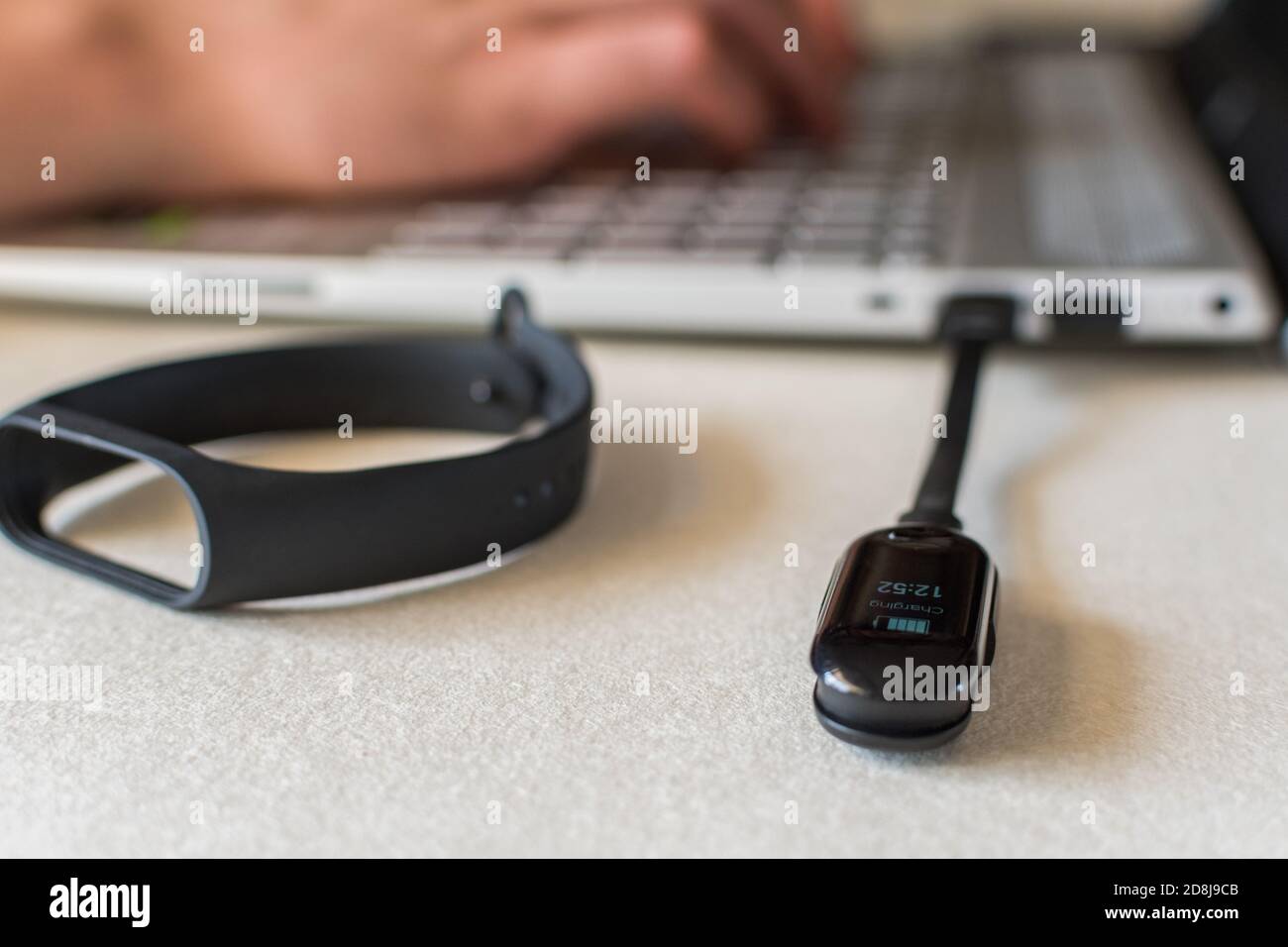 Closeup shot of charging smart band on laptop Stock Photo Alamy