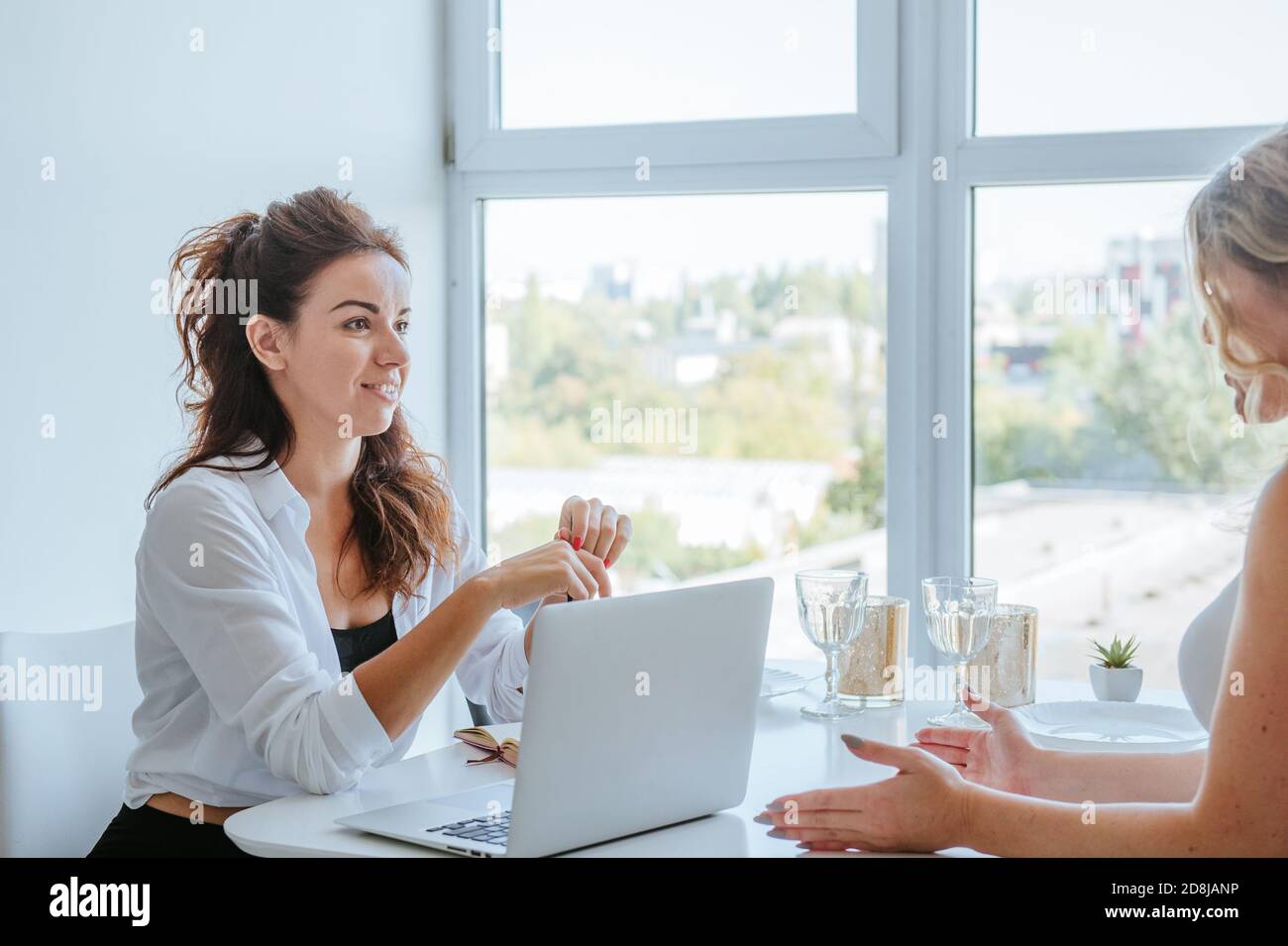 Female coach is consulting young woman indoor Stock Photo - Alamy