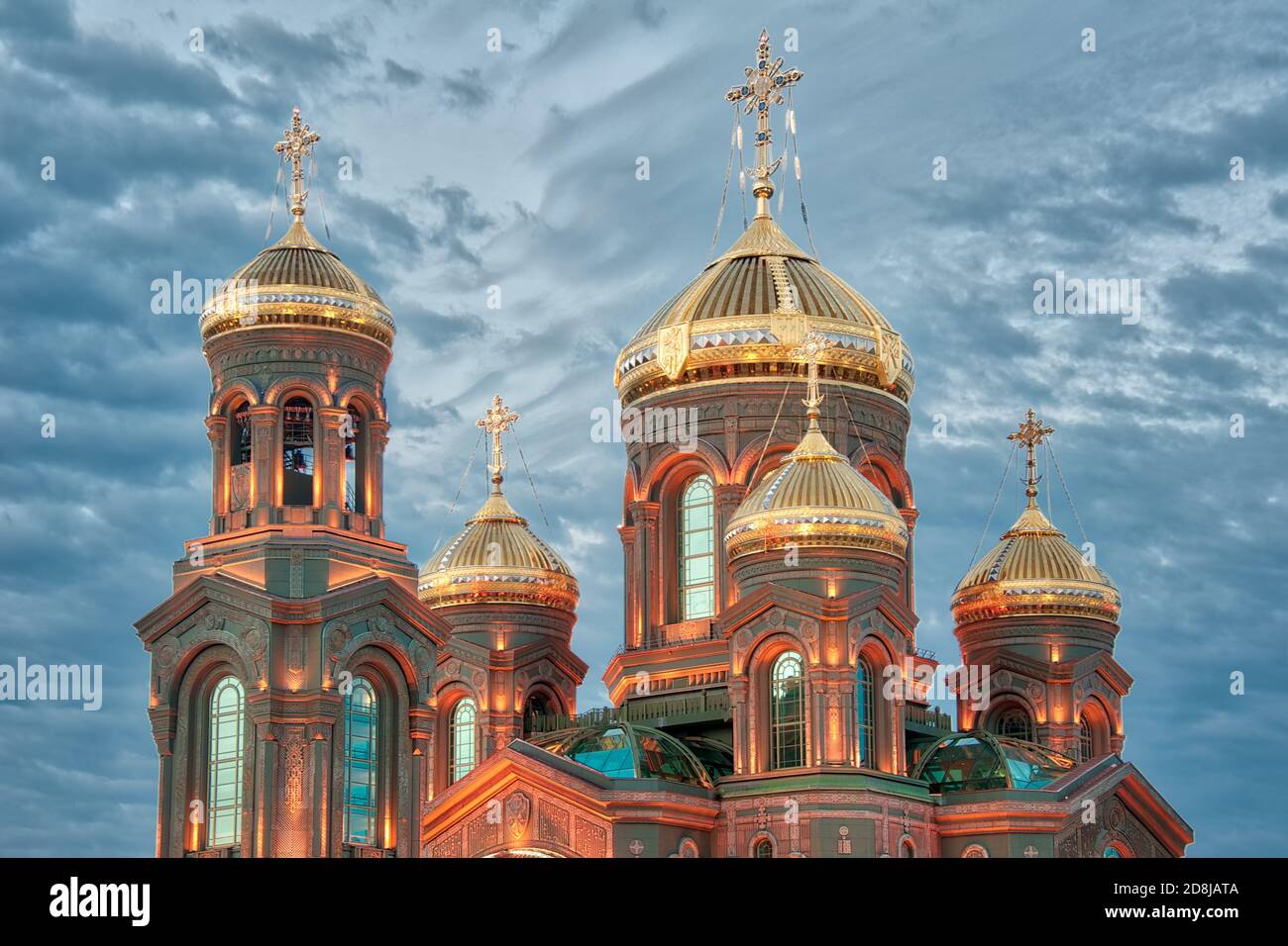 = Illuminated Domes of the Resurrection Cathedral in Twilight =  Shining gold domes (cupolas) of the Resurrection Cathedral, the Main Church of the Ru Stock Photo