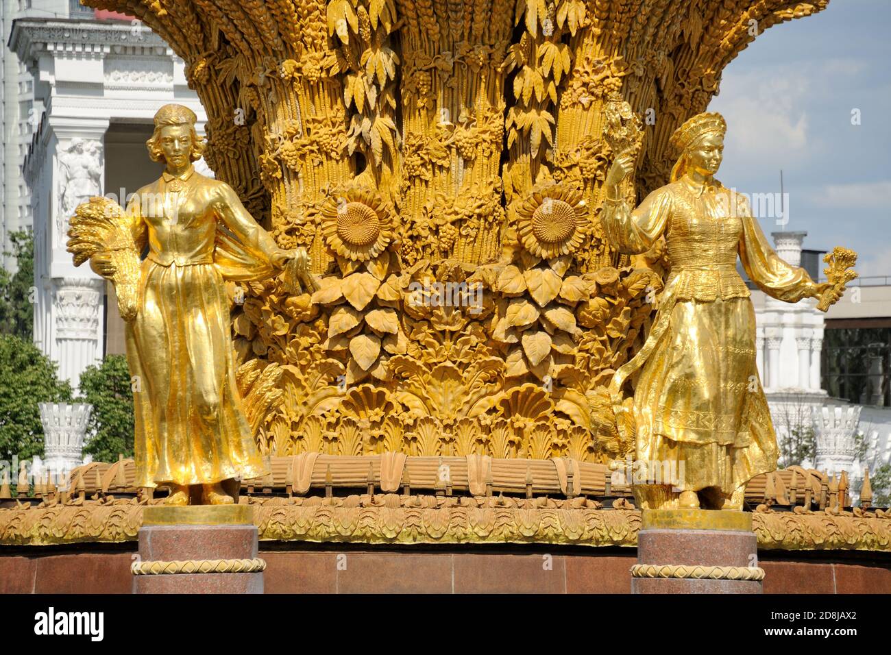 = Sculptures of Latvian and Lithuanian Republics =   Two of sixteen gilded beauties of the extravagant Friendship of Nations Fountain at VDNKh park an Stock Photo