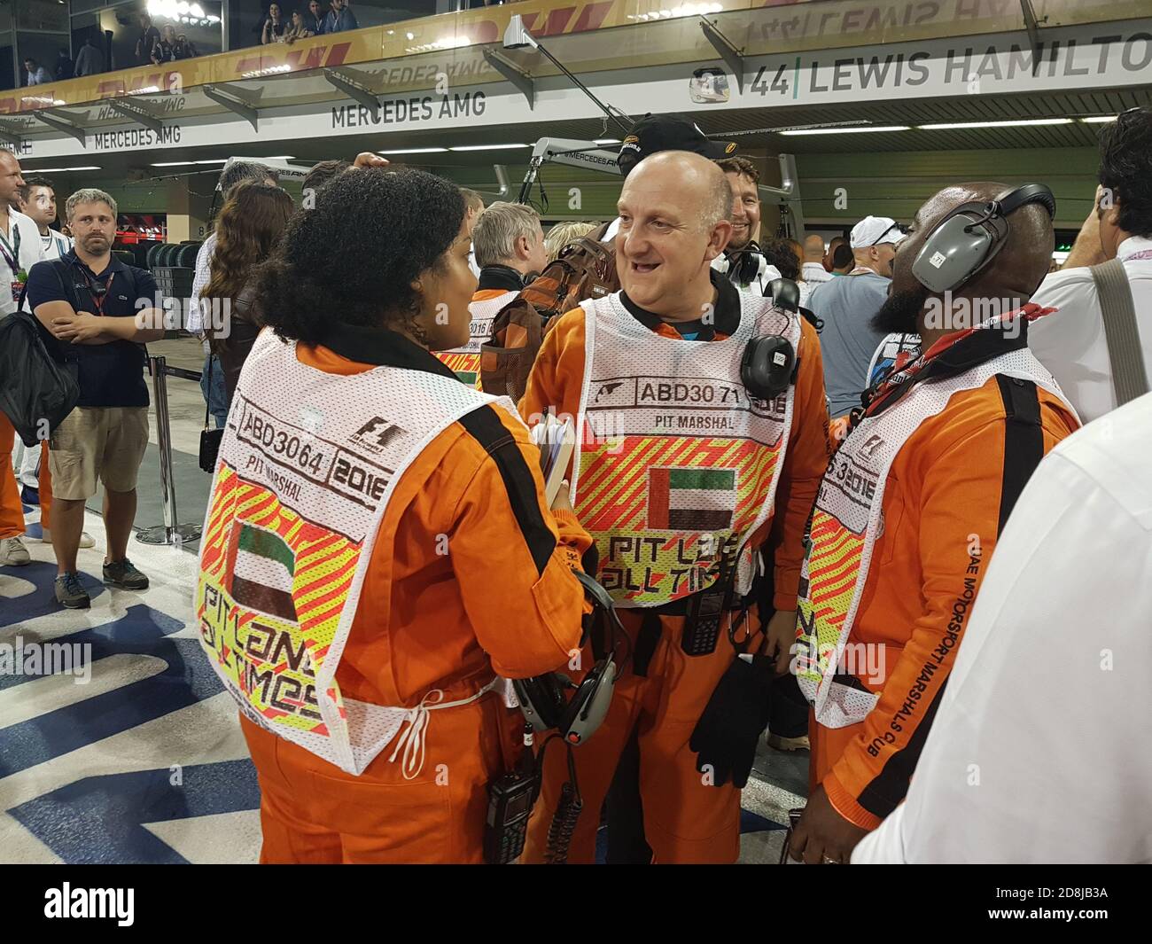 Pit Line Marshalls discuss the race in front of Lewis Hamilton's garage at Formula 1 Abu Dhabi Stock Photo