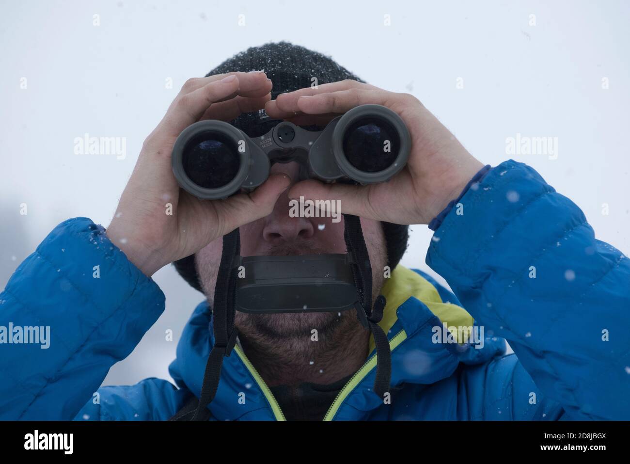 a person looking through binoculars to view far away objects Stock Photo -  Alamy