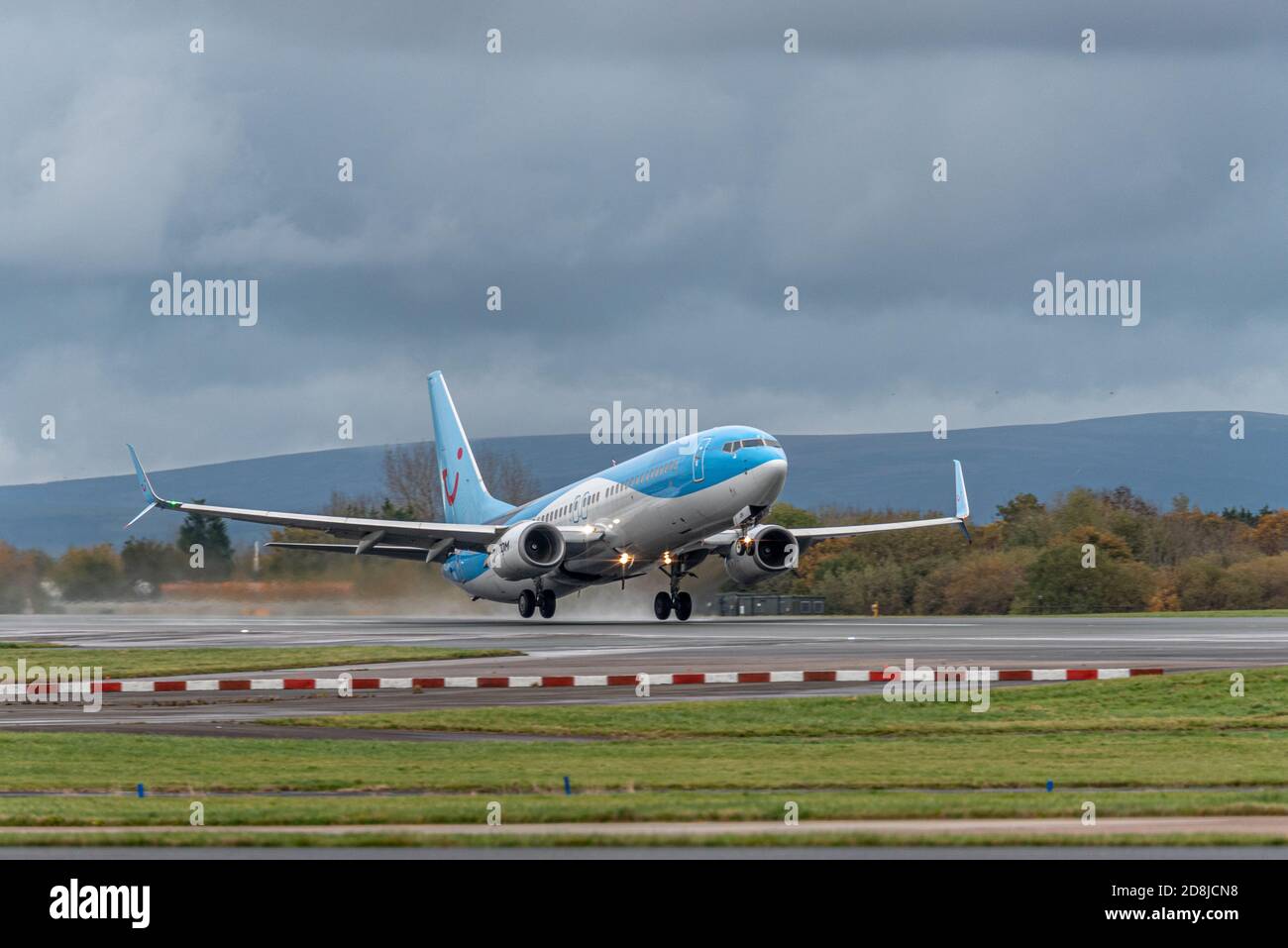 MANCHESTER, UK 30 OCTOBER 2020 - TUI Airways Boeing 737-8K5 flight BY2518 from to Corfu takes off from Manchester Airport in the rain. Stock Photo