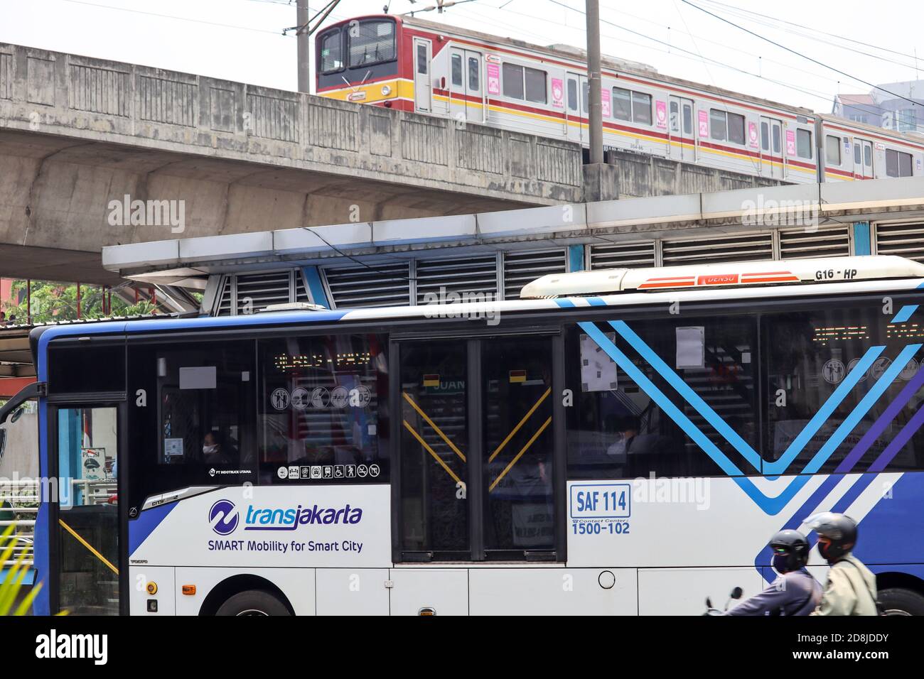 Jakarta / Indonesia - September 23, 2020. Integrated transportation between the Jakarta Commuterline electric train above and the Transjakarta public Stock Photo