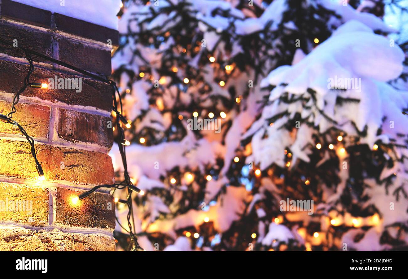 vintage brick wall Christmas background with lights glowing and snow ...