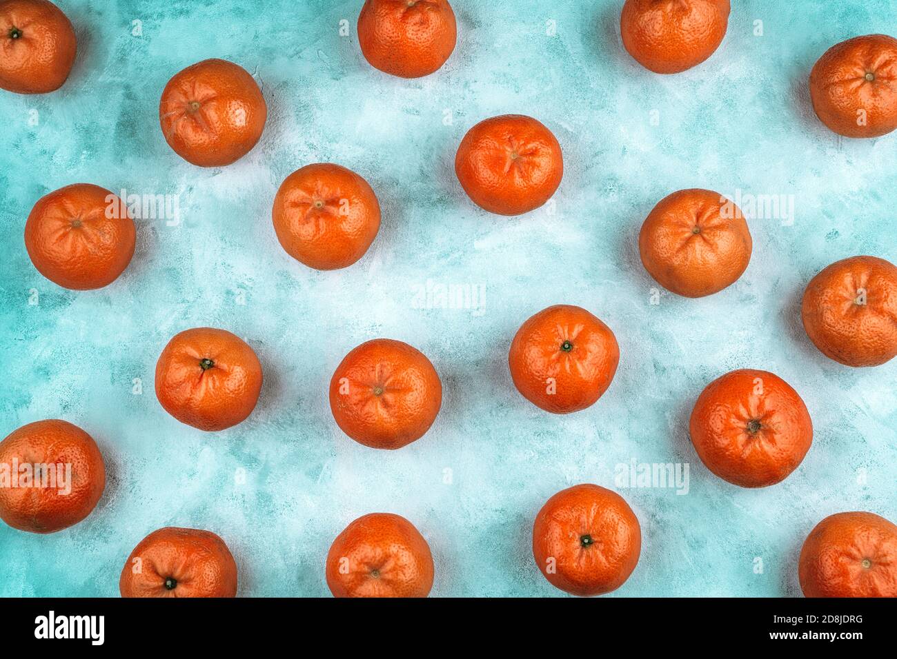 Abstract fruit background with tangerines on a blue background. Stock Photo