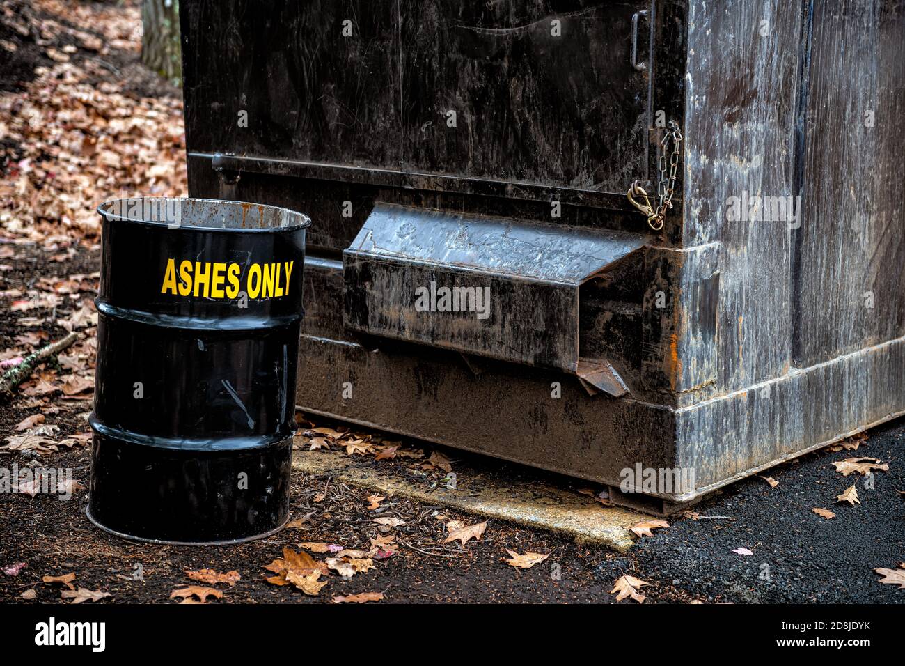 Ashes only sign on disposal barrel container for burnt firewood wood