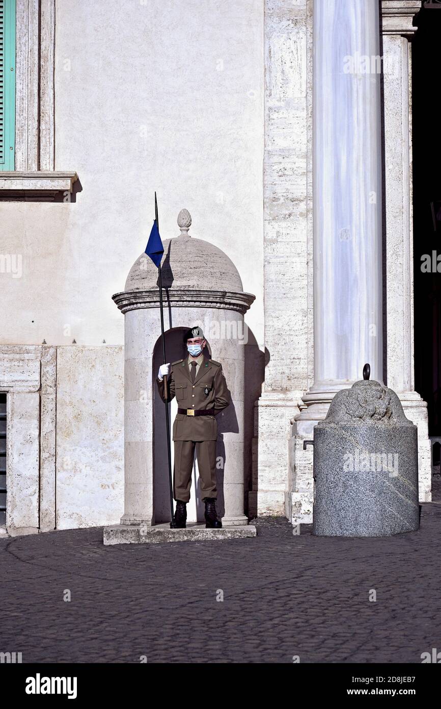 Quirinal Palace guard, wearing Covid 19 mask, on duty at the main gate. Rome, Italy, Europe, EU. Stock Photo