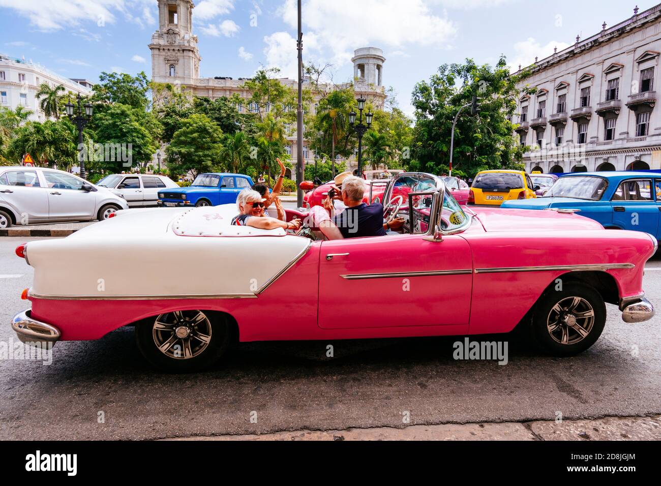 Tourists ride in a vintage taxi - Almendrón - around the Central Park - Parque Central. Havana. Cuba, Latin America and the Caribbean Stock Photo