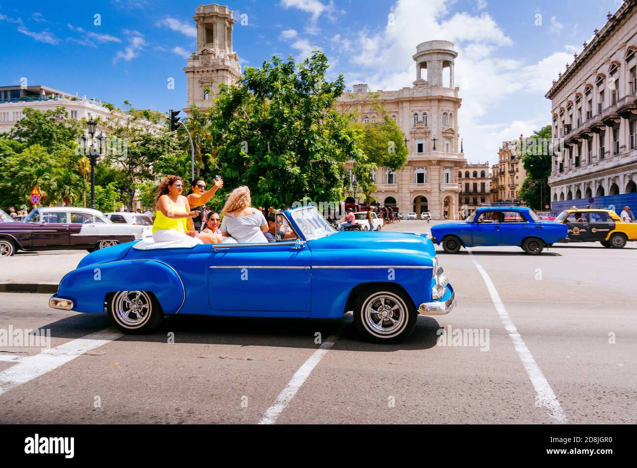 Female tourists ride in a vintage taxi - Almendrón - around the Central Park - Parque Central. Havana. Cuba, Latin America and the Caribbean Stock Photo