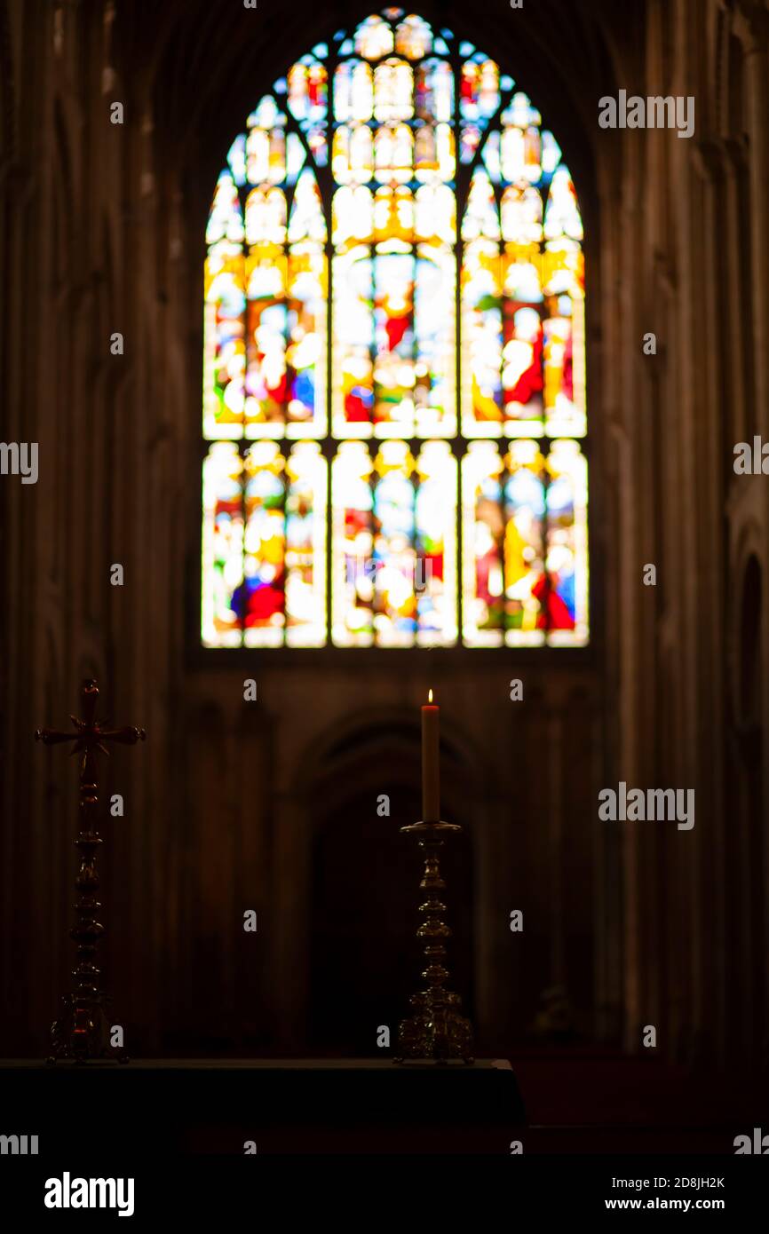 Inside of a historic church in England. Image shows a lit candle and a