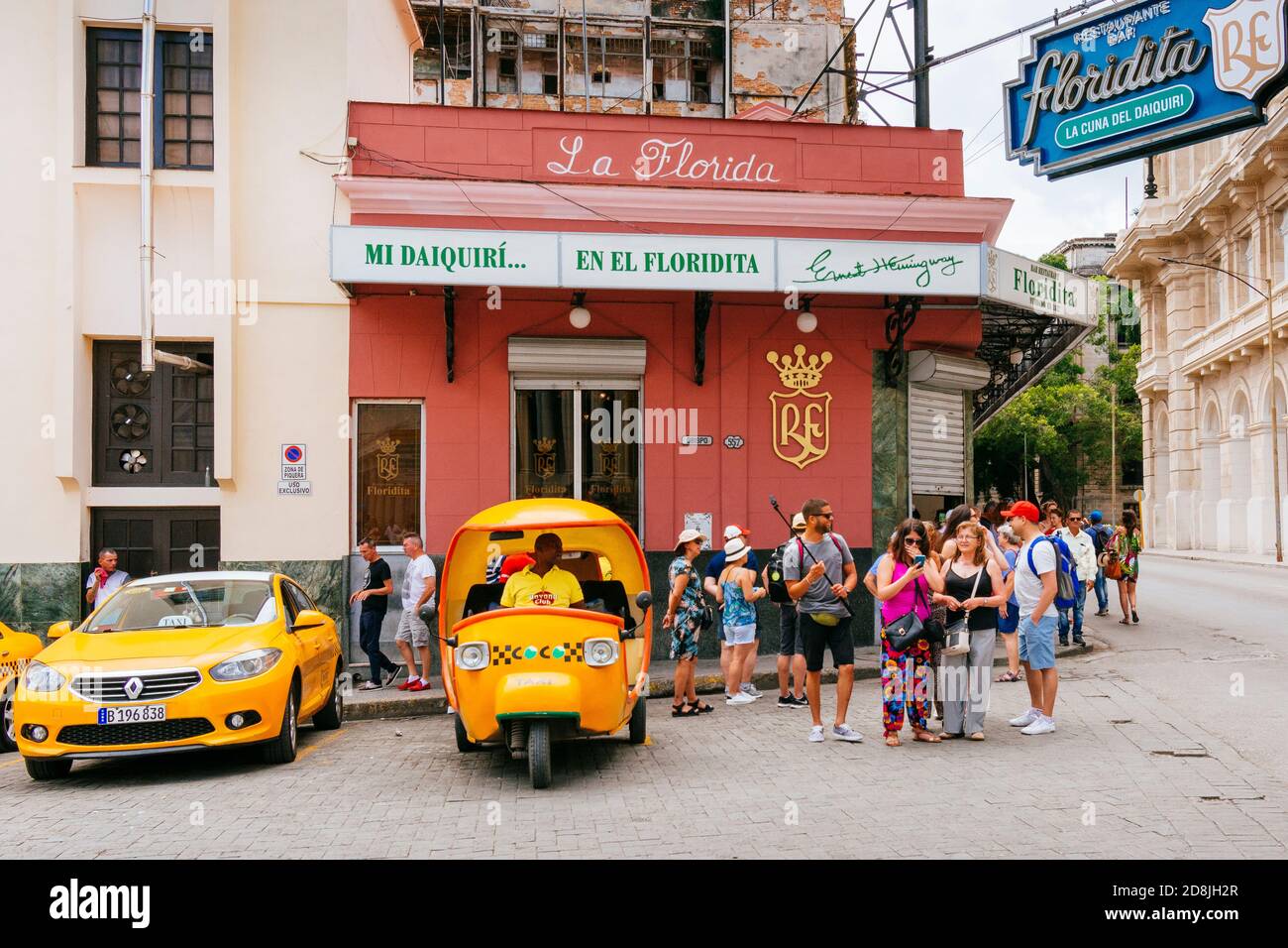 Coco-taxi next to El Floridita, venue for Daiquiri cocktail and Hemingway's favorite bar. La Habana - La Havana, Cuba, Latin America and the Caribbean Stock Photo