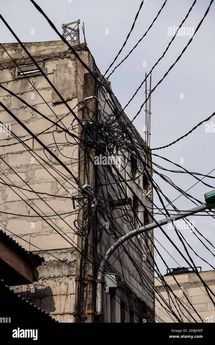 chaotic installation of electrical cables and fiber optic cable internet, suitable for wallpaper Stock Photo