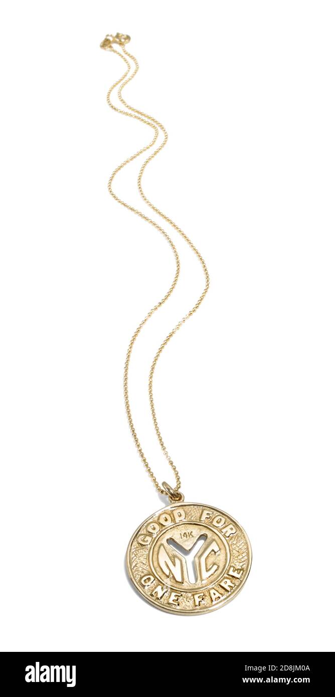 NYC subway token necklace that says 'Good for one fare' photographed on a white background Stock Photo