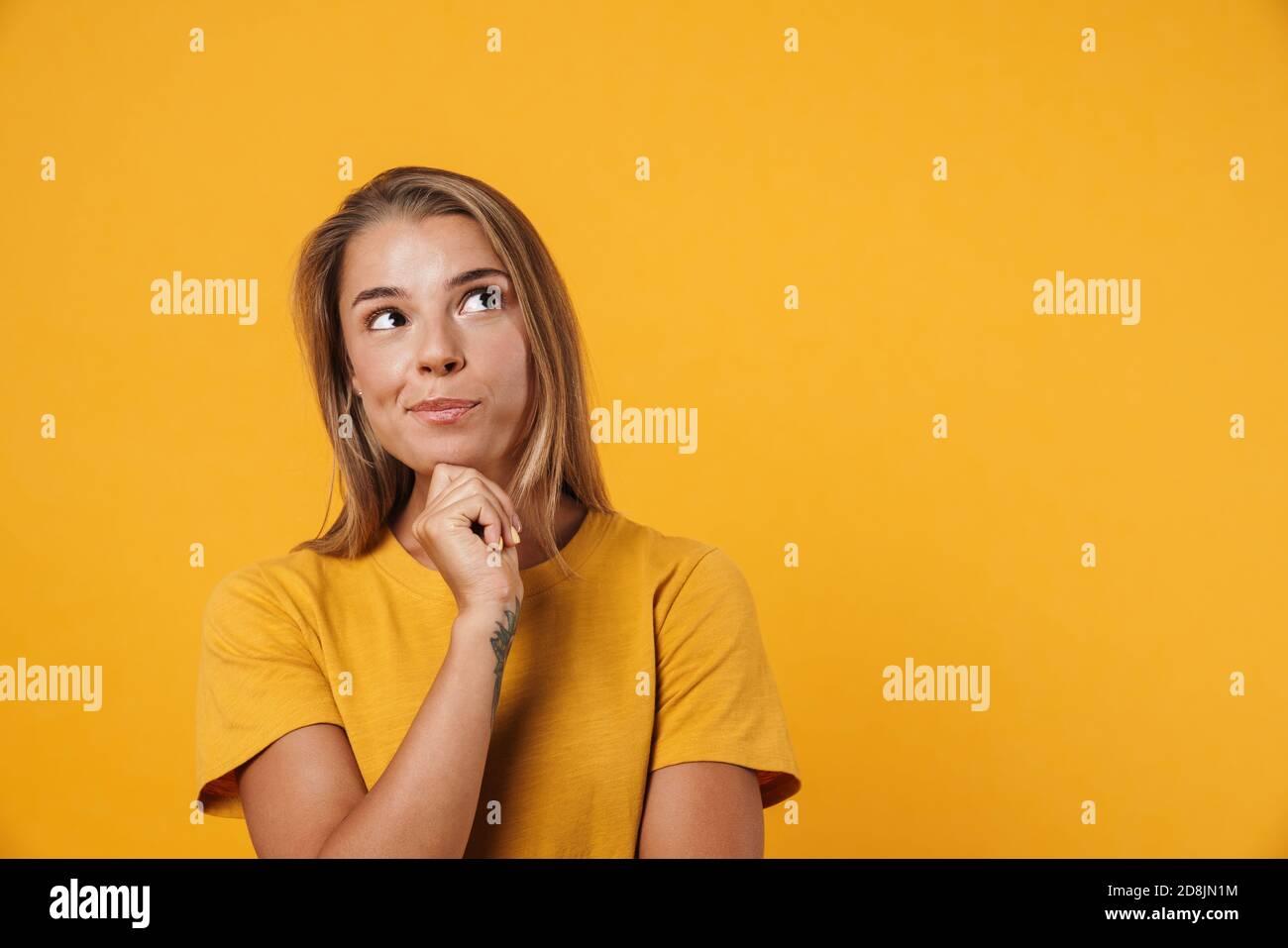 Image of blonde pleased woman thinking and looking upward isolated over ...