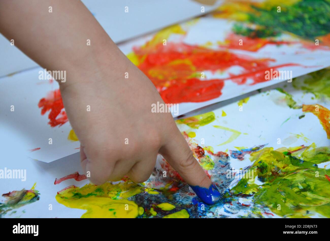 Kid Using Ink a child draws. a child's drawing inks, finger paints, hand prints with ...