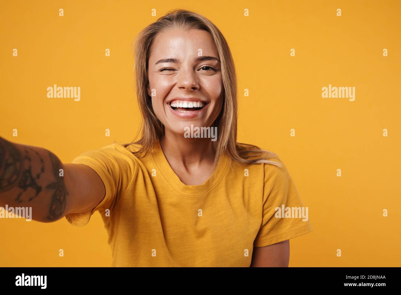 Image of young joyful woman winking and taking selfie photo isolated ...