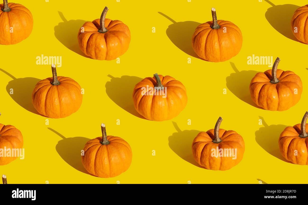 Pumpkin seamless pattern on orange background Stock Photo