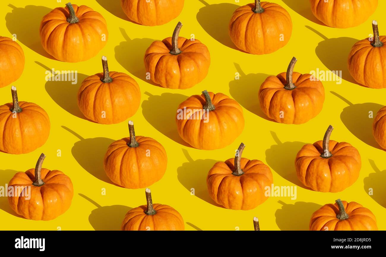 Pumpkin seamless pattern on orange background Stock Photo