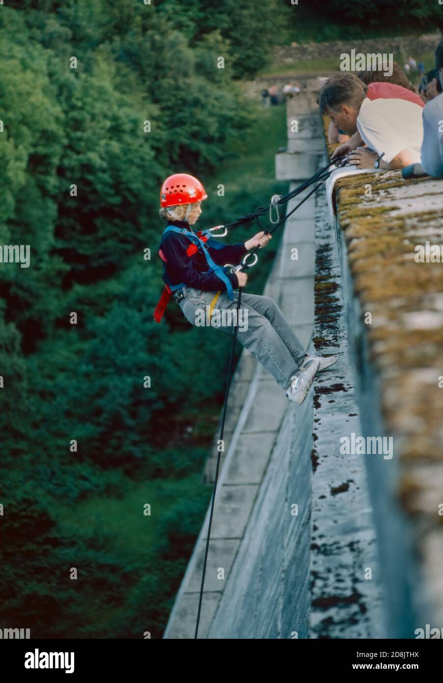 Learning to abseil from Haweswater Dam in Cumbria Stock Photo